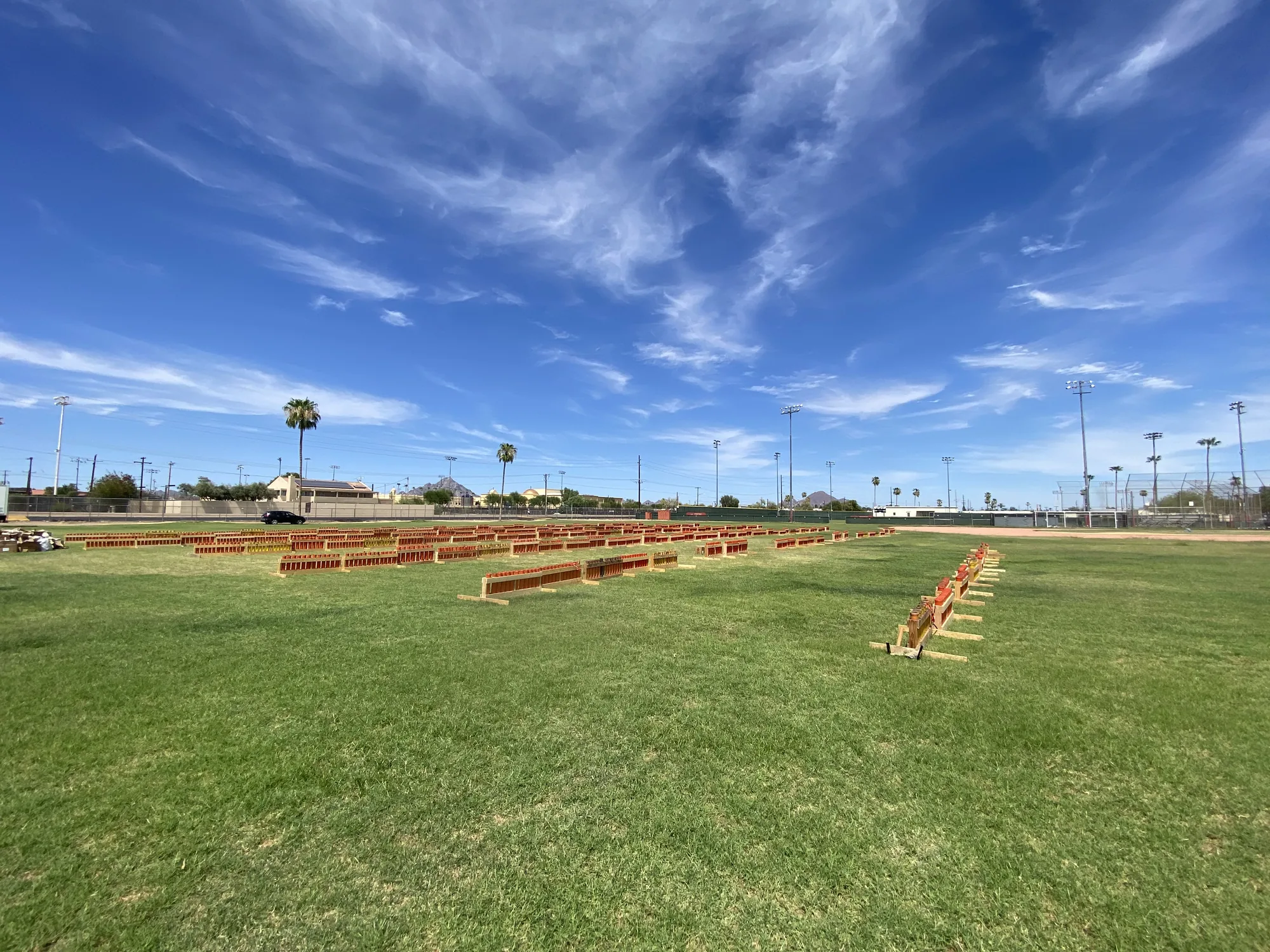 Professional fireworks firing area laid out in an open Arizona venue before guests arrive, showing the separation space that determines display-site feasibility.